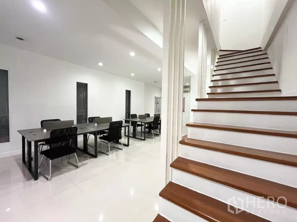 Home Office for rent in Bueng Kum, Bangkok - Wide timber staircase beside open-plan office seating.