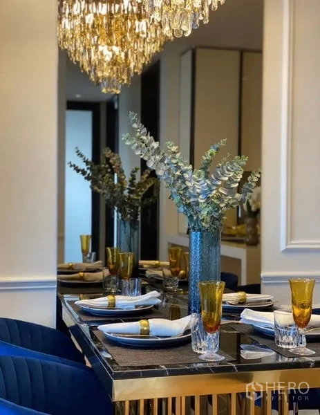 Condominium for rent - Table setting detail with eucalyptus centerpiece and crystal chandelier reflections.