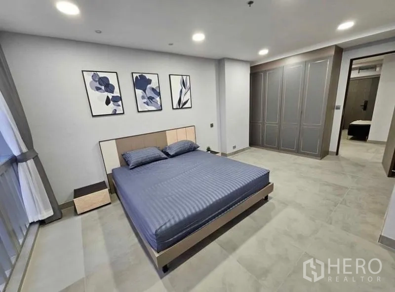 Condominium for rent or sale - Guest bedroom with built-in wardrobes and modern decor.