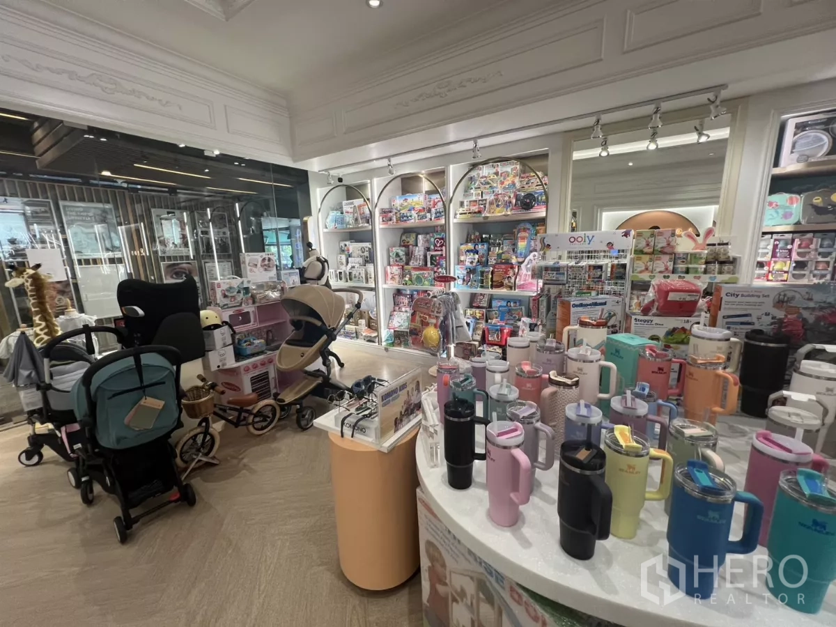 Retail Space for rent in Watthana, Bangkok - Central display island with drinkware and strollers, lit shelving and glass frontage.