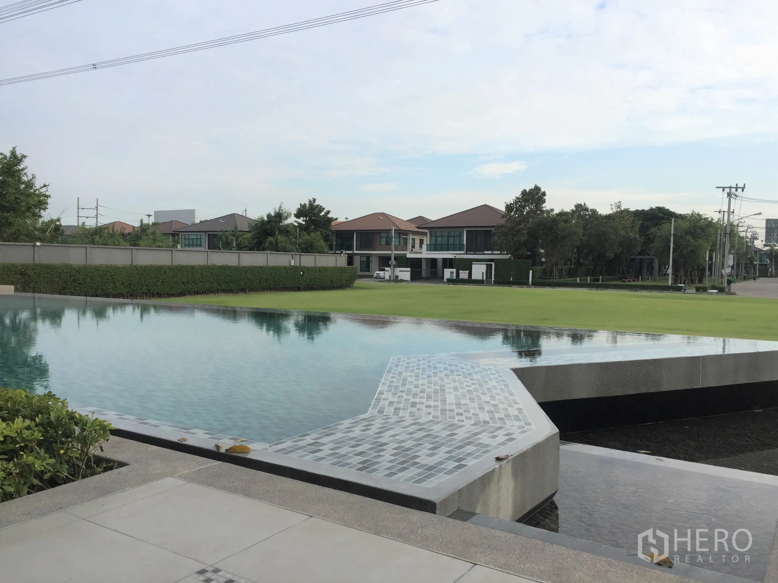 独立式住宅 出租或出售在Prawet, Bangkok - 社区设施示意：度假风无边泳池与大片草地。