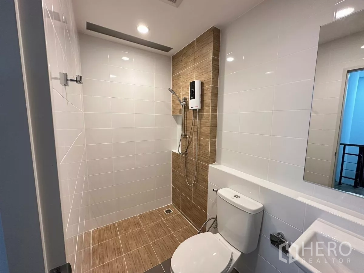 Townhouse for rent in Bang Phli, Samut Prakan - Bathroom with shower, water heater, toilet and wood‑tone tiles.