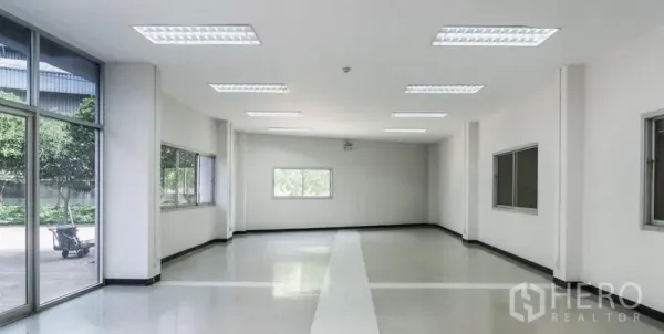 Warehouse for rent in Mueang Samut Sakhon, Samut Sakhon - Ground-floor office area with glass entrance, large windows, and ample natural light next to the warehouse floor.
