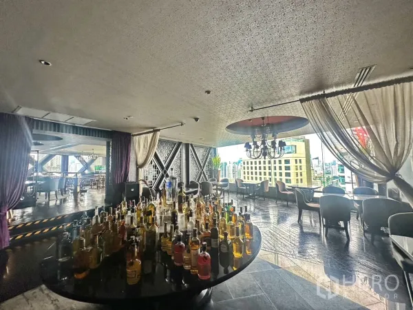 Retail Space for rent in Khlong Toei, Bangkok - Bright dining lounge with a round bottle display and panoramic city views.