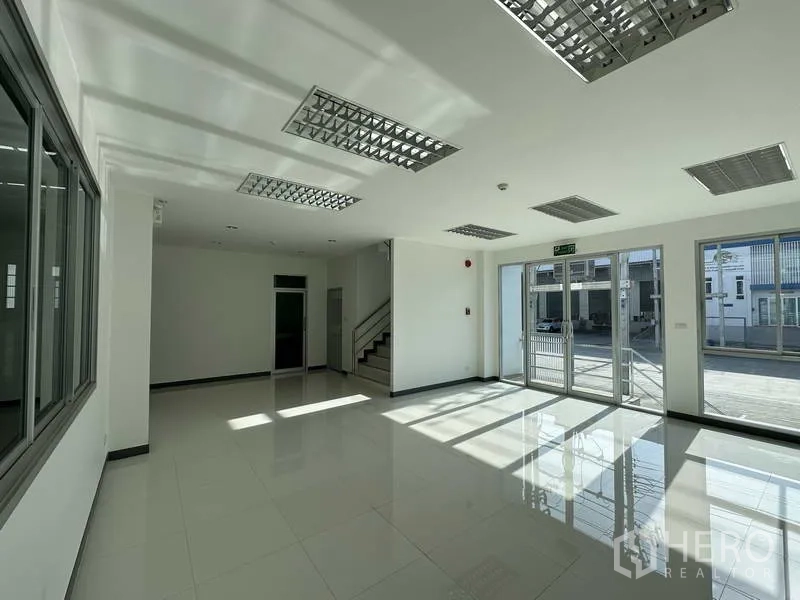 Factory for rent in Bang Sao Thong, Samut Prakan - Bright ground-floor office lobby with glass entrance and tiled floors.