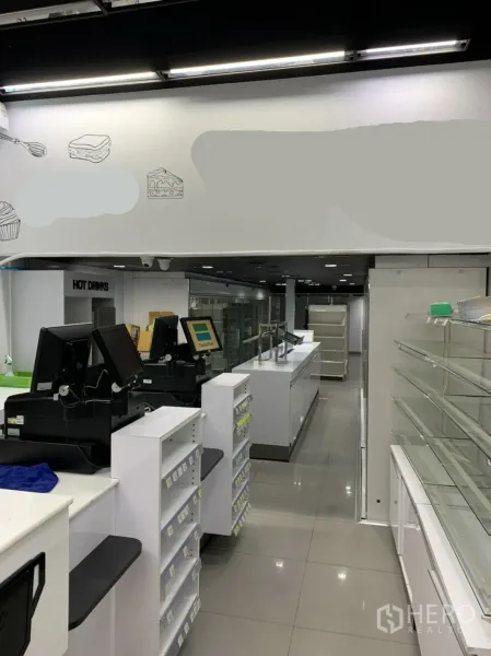 Retail Space for rent in Sathon, Bangkok - Front-of-house counter line with POS stations, glass display cabinets and glossy tiled floors.