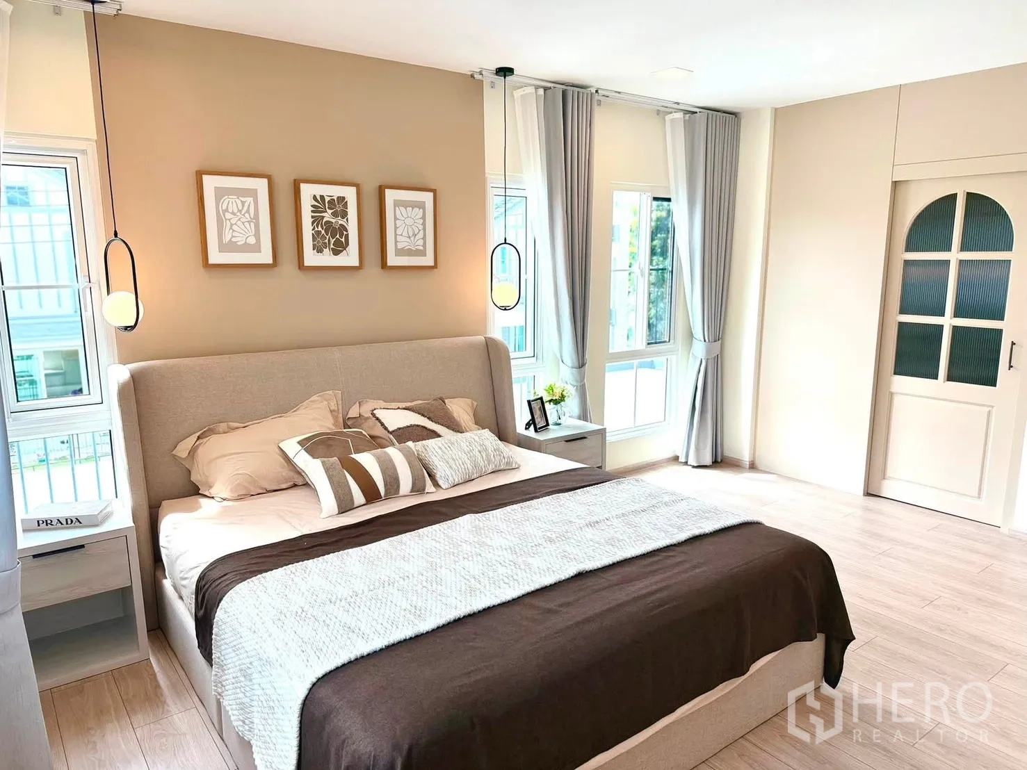 Detached House for rent in Bang Phli, Samut Prakan - Master bedroom angle showing pendant lights, corner windows, and sliding door.