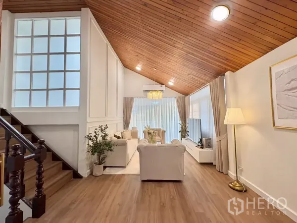 Detached House for rent in Huai Khwang, Bangkok - Open living space with staircase, paneled walls and timber ceiling