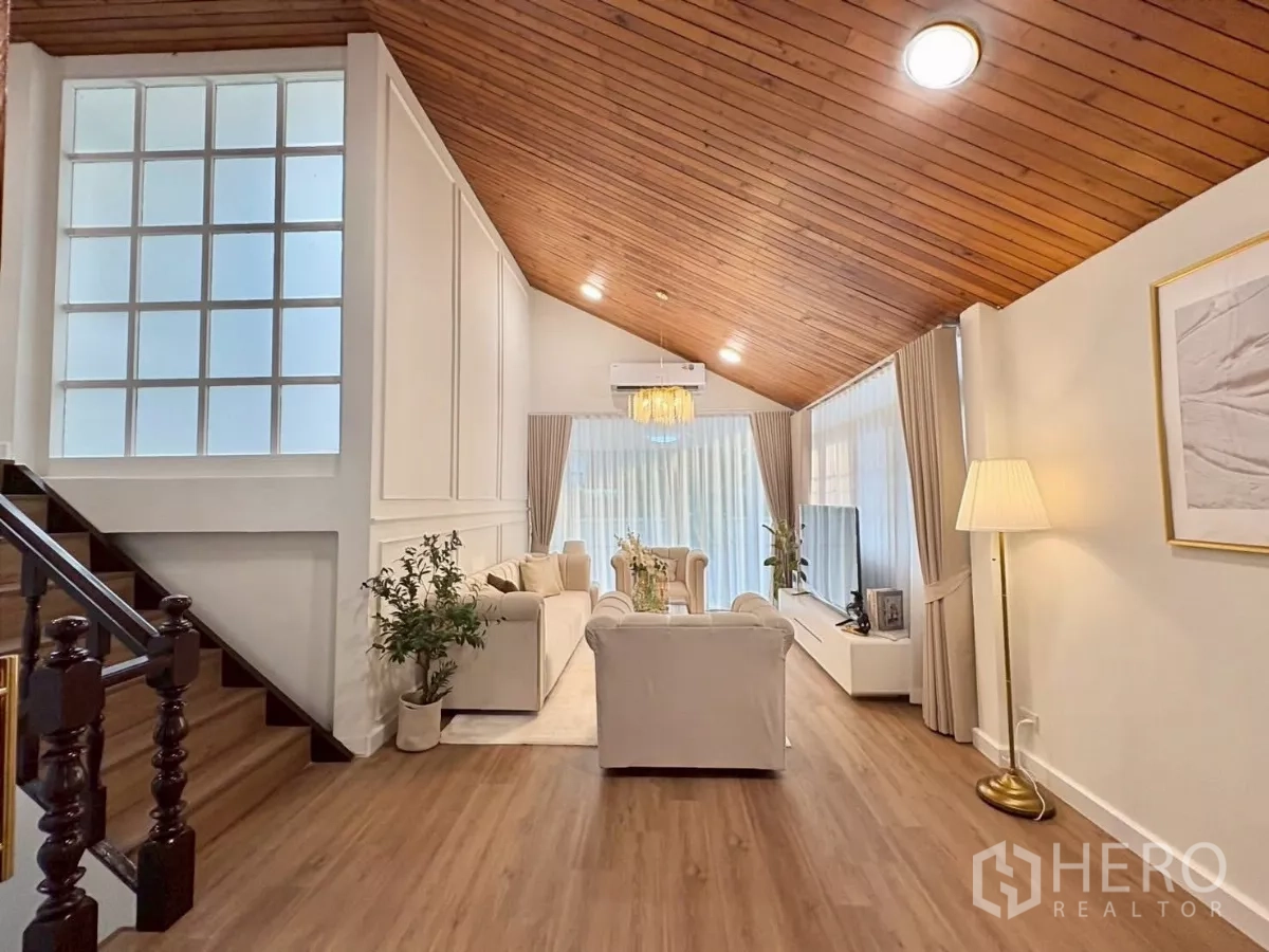Detached House for rent in Huai Khwang, Bangkok - Open living space with staircase, paneled walls and timber ceiling