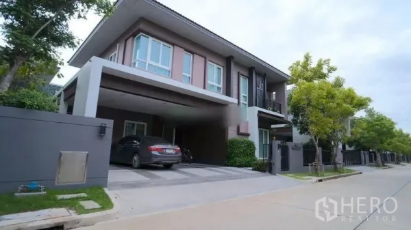 Detached House for rent or sale in Bang Phli, Samut Prakan - Modern two-storey detached house facade with a covered double carport on a quiet residential street.