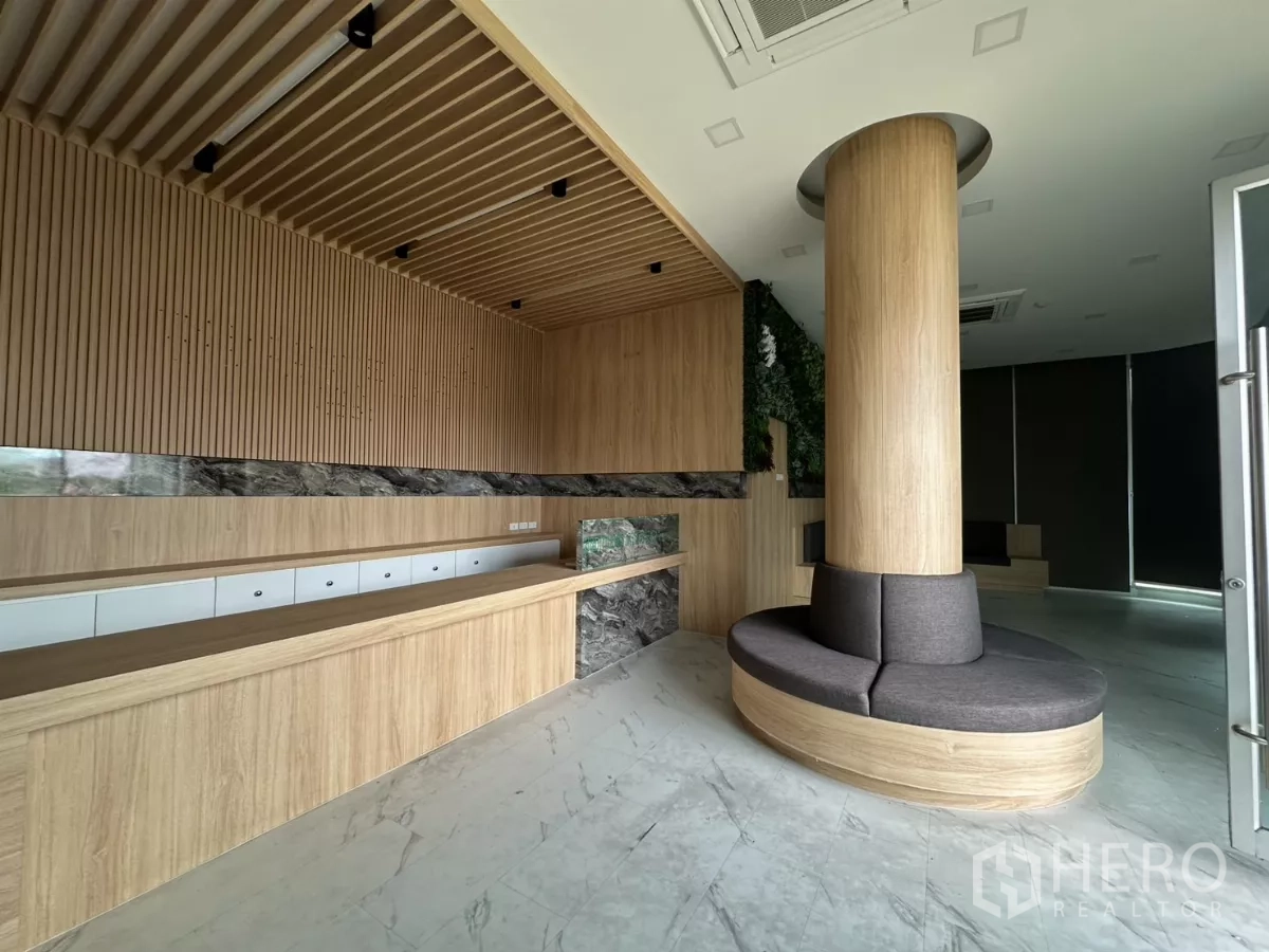 Retail Space for rent in Phra Khanong, Bangkok - Reception with wood‑slat ceiling, long service counter and round column seating in modern retail unit.