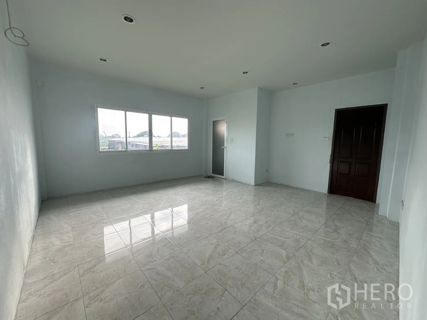 Home Office for rent - Another view of the corner room showing multiple windows and tiled floor.