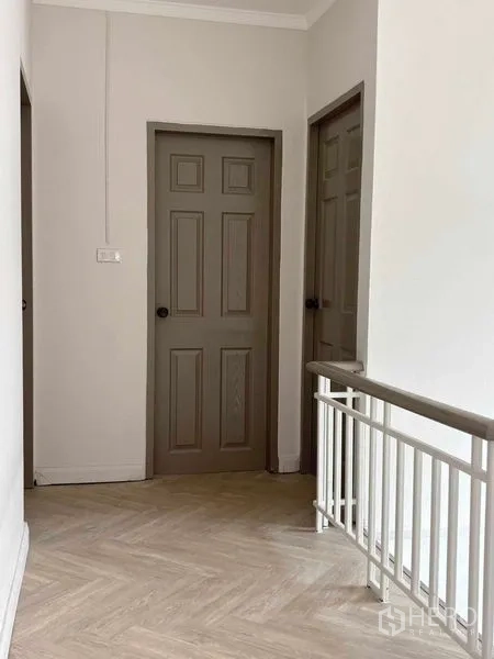 Detached House for rent or sale - Upstairs corridor with two doors and white railing.