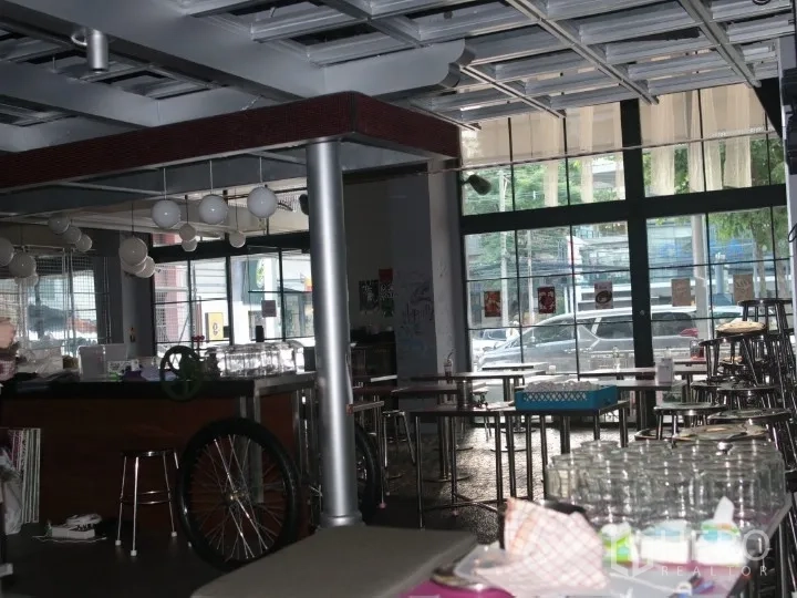 Retail Space for rent in Watthana, Bangkok - Former dining area with bar counter, tables, and large front windows.