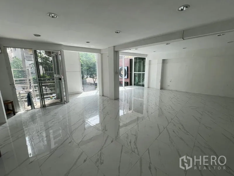 零售空间 出租在Khlong Toei, Bangkok - 明亮开放的零售室内，大采光窗与仿大理石地面，连通小露台。