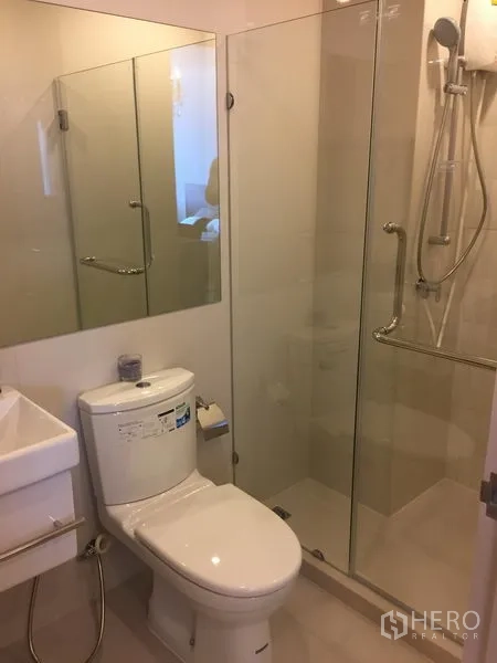 คอนโด ให้เช่าในHuai Khwang, Bangkok - ห้องน้ำสมัยใหม่พร้อมตู้ shower กระจกใส โถสุขภัณฑ์สีขาว และกระจกบานใหญ่