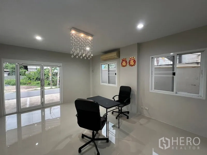 Warehouse for rent in Prawet, Bangkok - Reception office with chandelier lighting and wide sliding glass doors.