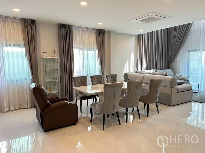 Detached House for rent in Bang Phli, Samut Prakan - Bright dining room with marble table for eight, recliner and sheer curtained windows.
