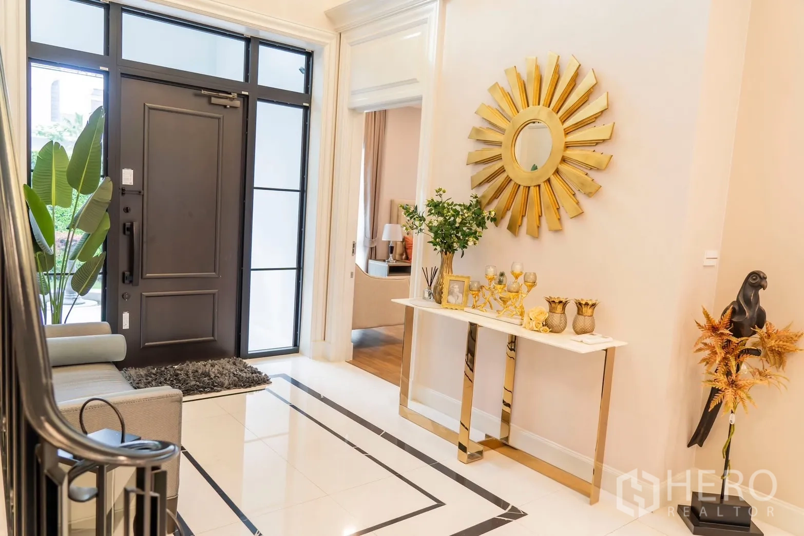 Detached House for rent in Saphan Sung, Bangkok - Grand entry hall with black door, gold console and sunburst mirror.