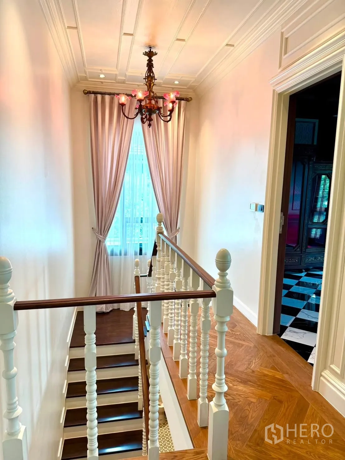 Detached House for rent in Bang Kapi, Bangkok - Staircase with white balustrade, wooden steps, and vintage chandelier.