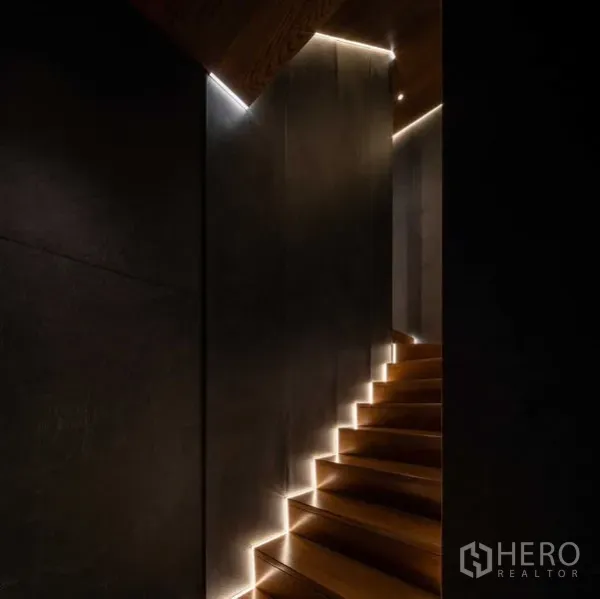 Detached House for sale in Saphan Sung, Bangkok - Warm-lit wooden staircase with recessed LED lights in a Saphan Sung house.