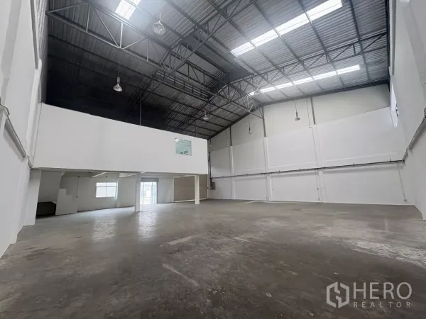 Factory for rent in Phra Samut Chedi, Samut Prakan - Wide warehouse bay with smooth concrete floor and mezzanine rooms.