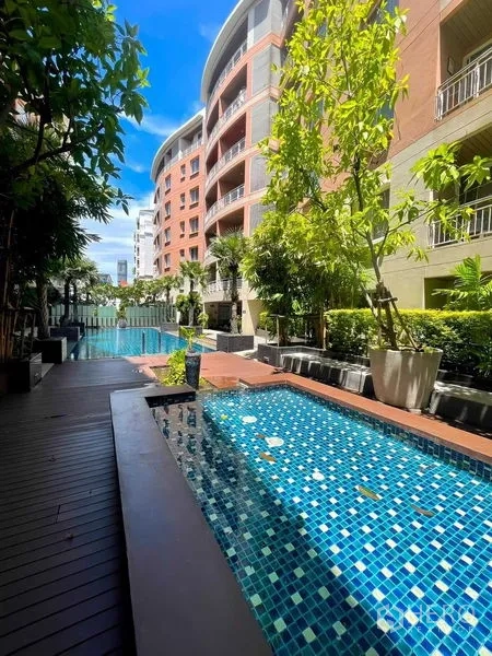 Condominium for rent - Poolside jacuzzi beside the main swimming pool with landscaped deck and greenery.