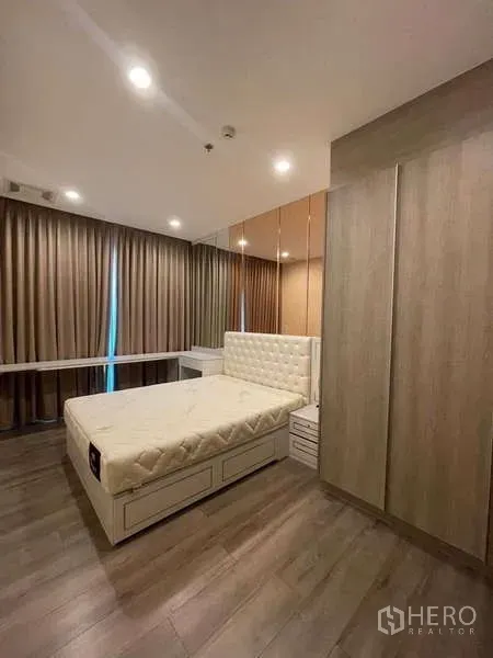 公寓 出租 - 主卧配软包床、镜面墙、内置衣柜、木地板与遮光窗帘。