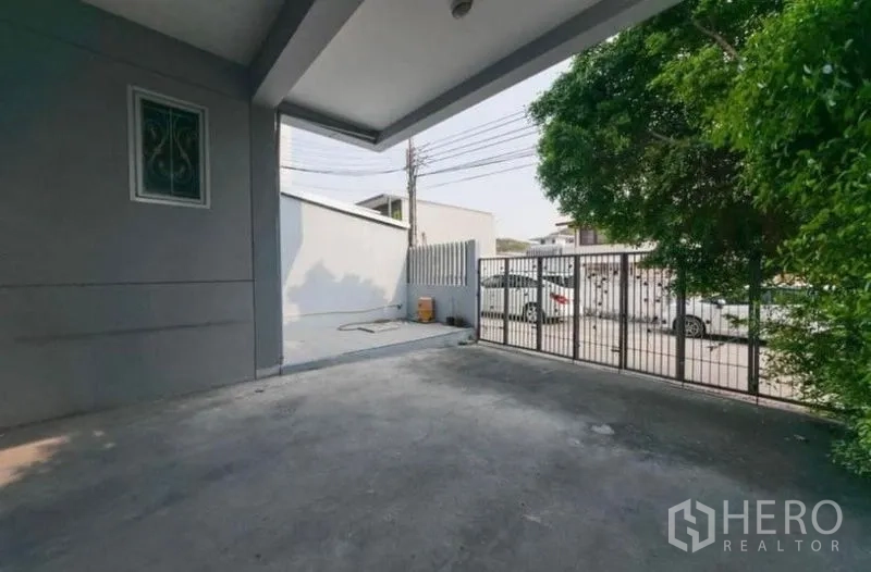 สำนักงานที่บ้าน ให้เช่าหรือขาย - ที่จอดรถในร่มพร้อมประตูรั้วหน้าอาคารและพื้นคอนกรีต