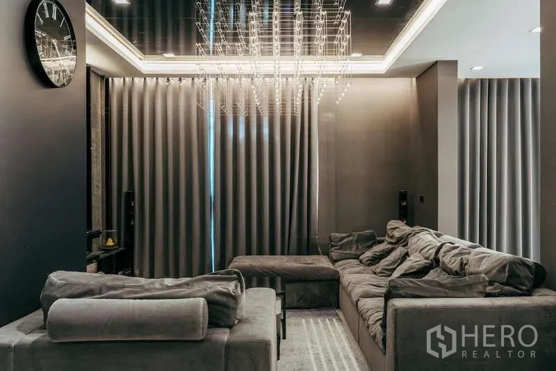 Detached House for sale in Sai Mai, Bangkok - Living area view with plush sectional sofas and a statement chandelier.