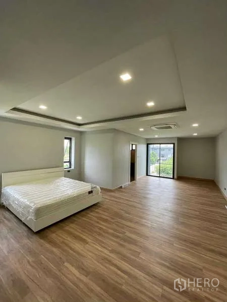 Home Office for rent in Khan Na Yao, Bangkok - Master bedroom layout showing bed area, recessed ceiling lights and a balcony door.