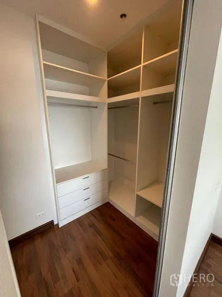 Condominium for sale - Walk-in closet with built-in drawers and hanging space.