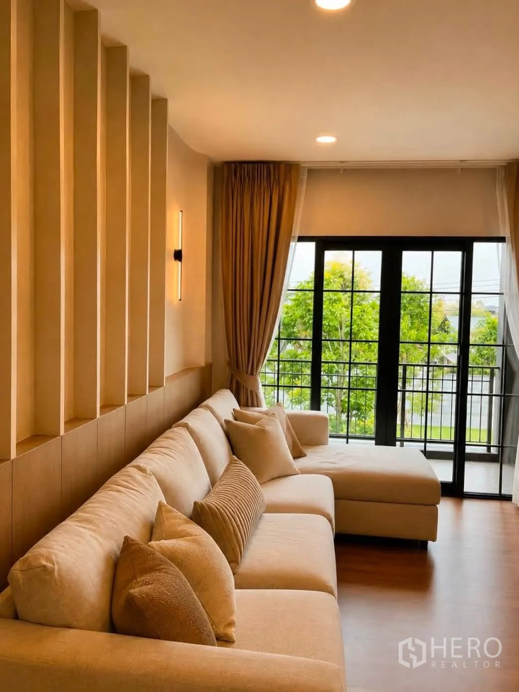 Detached House for rent in Bang Phli, Samut Prakan - Upstairs family room with a long sofa and balcony doors framed by curtains.