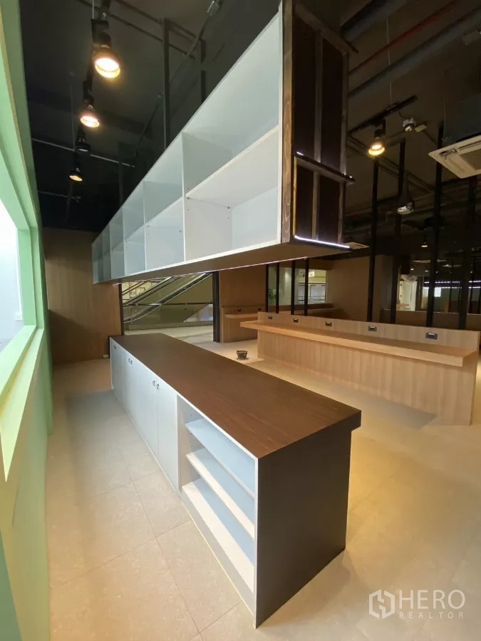 Retail Space for rent - Close-up of island counter featuring storage shelves and a suspended display unit.