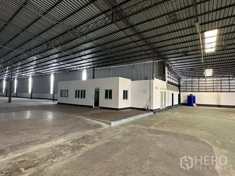 Warehouse for rent in Khan Na Yao, Bangkok - On‑floor office suite inside the warehouse with multiple windows and access doors.