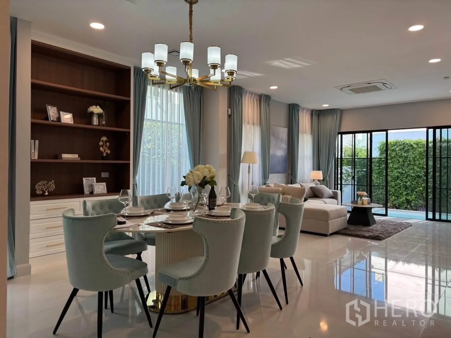 Detached House for rent in Saphan Sung, Bangkok - Open-plan living and dining space with floor-to-ceiling windows beside the pool.