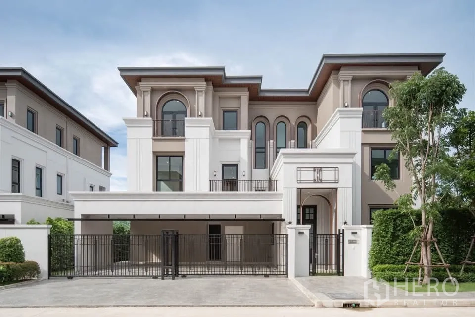 Detached House for rent or sale in Saphan Sung, Bangkok - Grand three-storey detached house facade with gated covered parking.