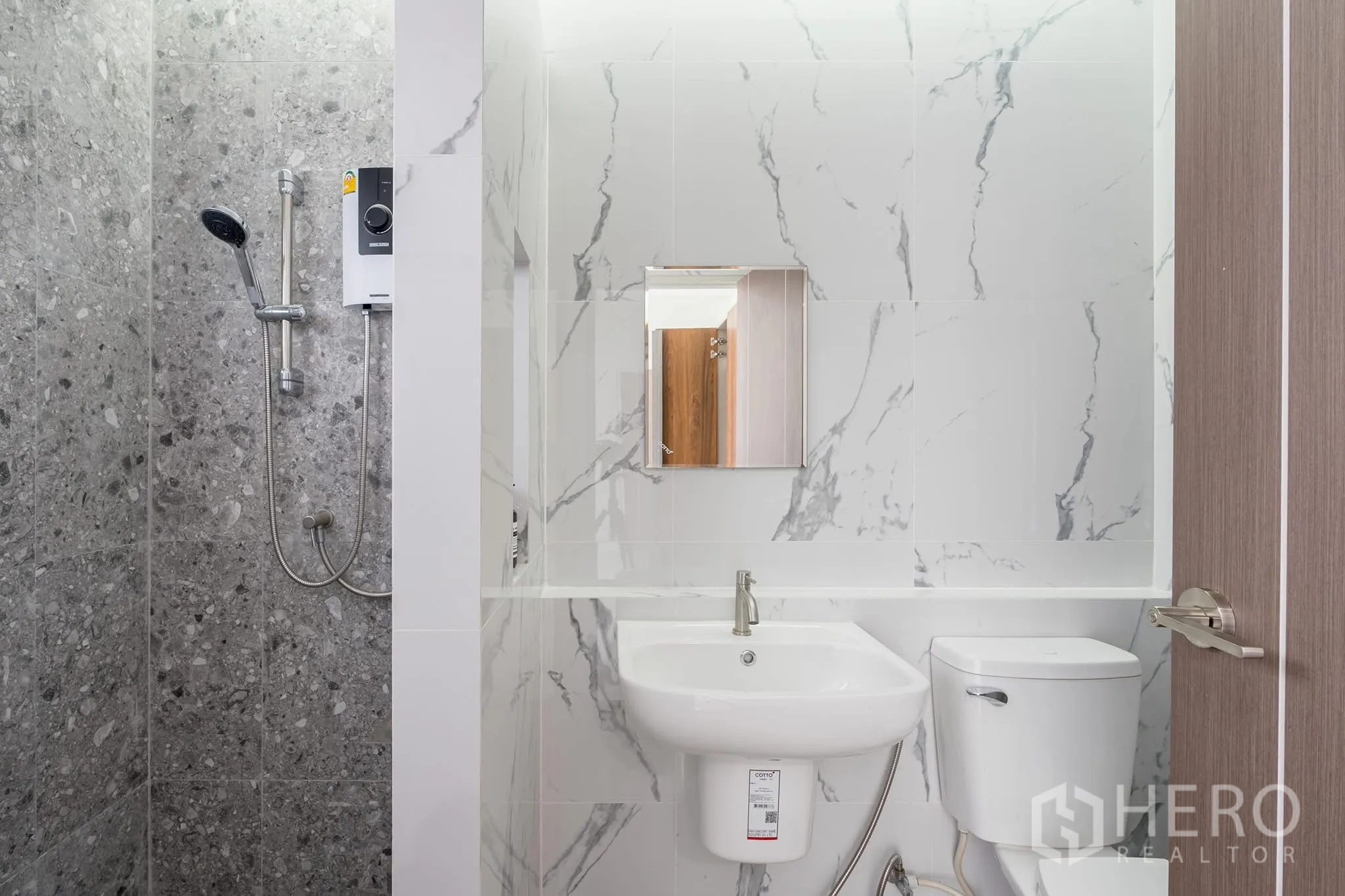 Home Office for rent in Khlong Toei, Bangkok - Bathroom featuring grey stone-tile shower, white vanity and electric water heater.