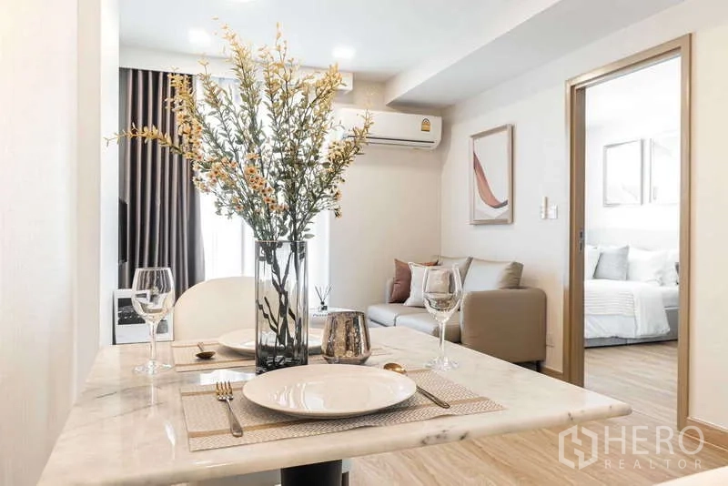 Condominium for rent - Dining table set for two with vase centerpiece overlooking the lounge.