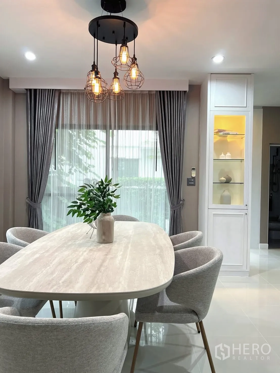 Detached House for rent in Prawet, Bangkok - Close view of dining area with sliding glass doors and an illuminated display cabinet.