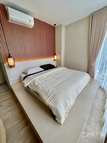 Condominium for sale - Master bedroom with platform bed, wood slat headboard and pendant bedside lights.