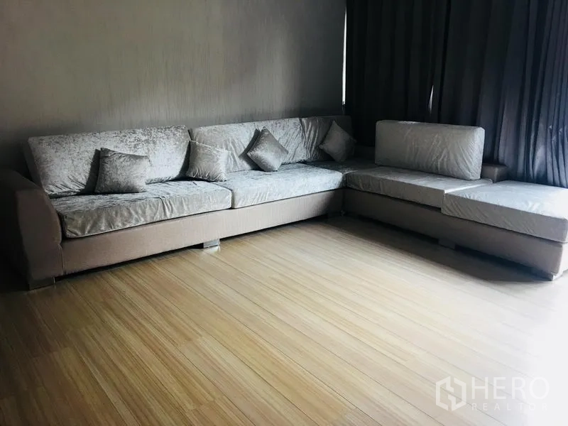 ทาวน์เฮาส์ ให้เช่าในYan Nawa, Bangkok - ห้องพักผ่อนชั้นบน โซฟาตัวยาว พื้นลายไม้ และผ้าม่านกันแสง