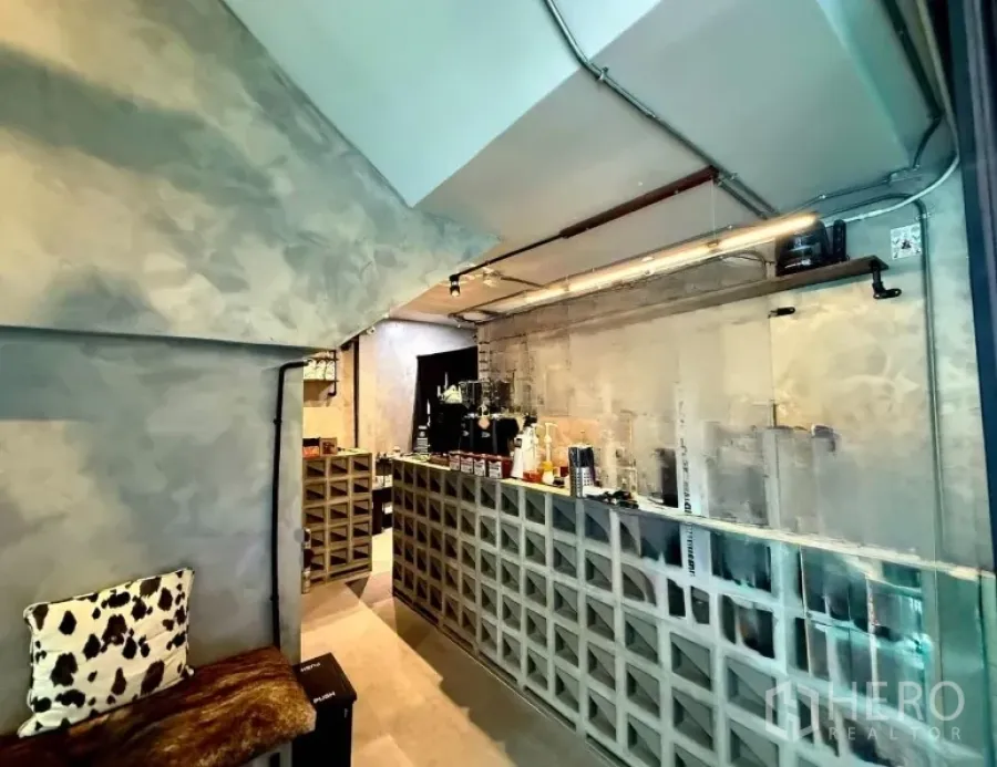Retail Space for rent in Khlong Toei, Bangkok - Industrial-style coffee bar with grid-block counter, brewing equipment and exposed ceiling pipes in a compact shop.