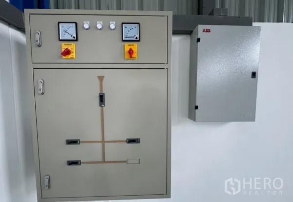 Warehouse for rent in Lam Luk Ka, Pathum Thani - Electrical control panel and power distribution boxes mounted on a warehouse wall.