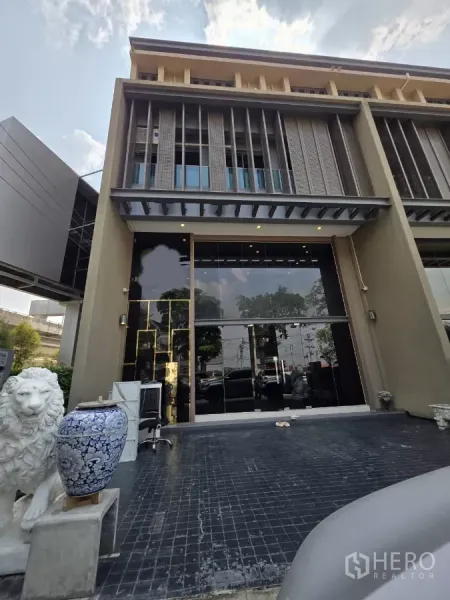 Home Office for rent in Pak Kret, Nonthaburi - Modern three-storey home office facade with double-height glass frontage in Pak Kret, Nonthaburi.