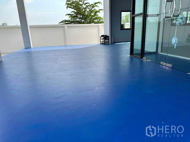 คลังสินค้า ขายในKhlong Luang, Pathum Thani - เฉลียงพื้นอีพ็อกซี่สีน้ำเงินถัดจากประตูกระจกและกำแพงรั้ว
