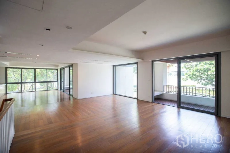 Condominium for rent in Yan Nawa, Bangkok - Upper-level living space with dual balconies and full-height windows.