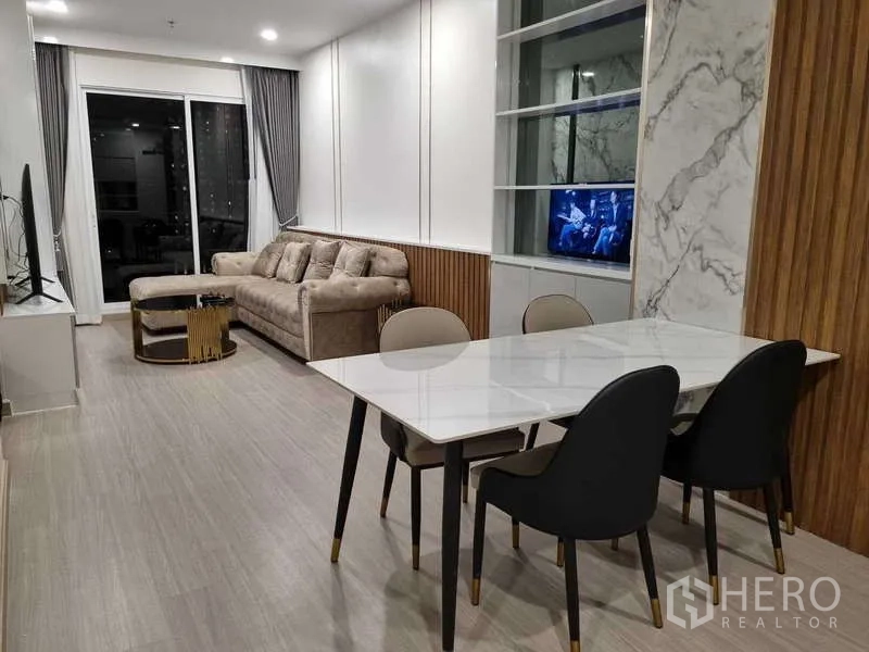 Condominium for rent - Open-plan living and dining room with sofa and access to the balcony.