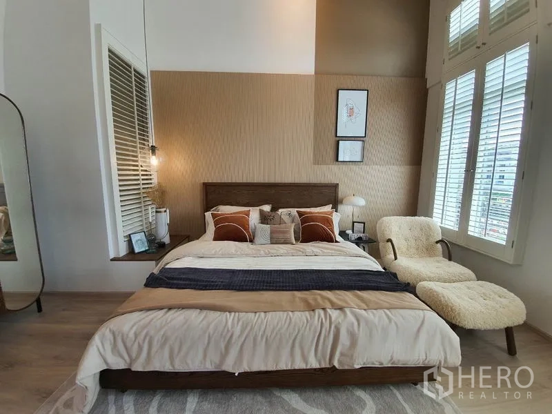 บ้าน ให้เช่าในPrawet, Bangkok - ห้องนอนใหญ่หน้าต่างบานเกล็ดสูง เก้าอี้นวมยาว โทนอบอุ่น