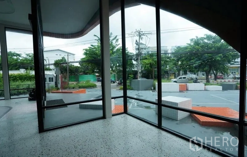 Standalone for rent in Bang Na, Bangkok - Panoramic corner glazing overlooking the front plaza and street access.